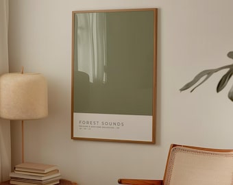 May include: A rectangular wall art print in a thin wooden frame featuring a solid olive green background with a white bottom border containing the text FOREST SOUNDS, followed by smaller text reading COLOURS & EMOTIONS COLLECTION 08 and 48 188 107.