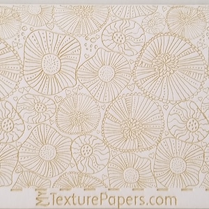 May include: White background with a repeating pattern of gold, stylised floral designs. The design is called "100246" and is from TexturePapers.com.