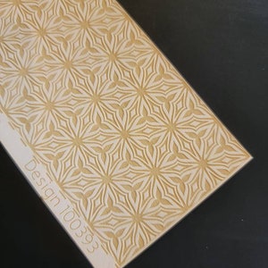May include: A white rectangular surface with a repeating pattern of gold stars. The text "Design 100393" is printed in the bottom left corner.