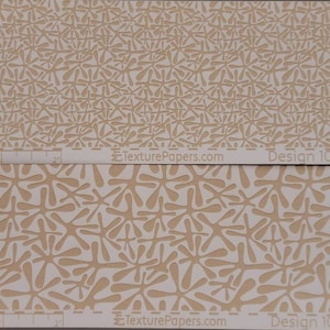May include: Two samples of textured paper with a repeating pattern of white stylized flowers on a beige background. The text "TexturePapers.com" and "Design 100350A" are printed on the top sample, and "TexturePapers.com" and "Design 100350B" are printed on the bottom sample.