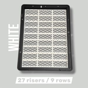 May include: A black rectangular tray filled with 27 white risers arranged in 9 rows. Each riser features a repeating black wave pattern. The word "WHITE" is printed vertically on the left side of the image. The text "27 risers / 9 rows" is at the bottom.