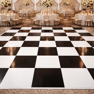 May include: Elegant ballroom with a black and white checkered dance floor. Tables are set with white linens and gold chairs. Chandeliers and floral arrangements add to the formal ambiance, creating a sophisticated event space.