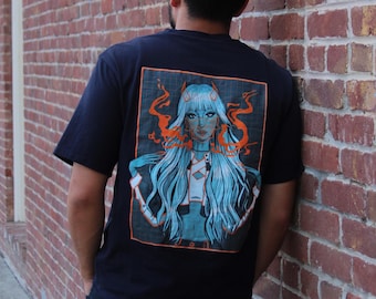 May include: A black t-shirt with a graphic print of a blue-haired woman with orange flames behind her. The graphic is in a square frame with a black background and orange border. The text "J.O.N" is printed at the bottom of the graphic.