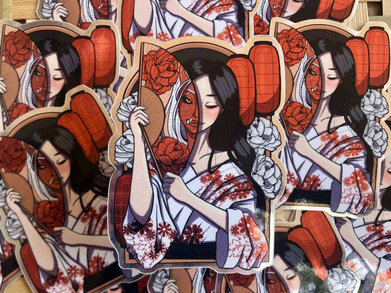 May include: Stickers featuring a geisha-inspired design. The artwork depicts a woman in a kimono, holding a fan, with half her face as a demon. The color palette includes white, red, and black.