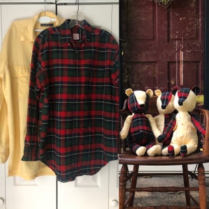 May include: A red and green plaid button-down shirt with a yellow button-down shirt hanging next to it. Three stuffed badger toys are sitting on a wooden chair.