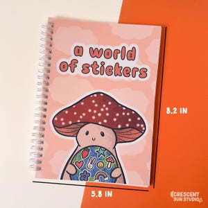 Spiral bound book with a background of peachy clouds. Coral text reads "a world of stickers." Below that is a happy mushroom holding a globe covered in stickers.

Image shows size of stickerbook - 5.3 inches wide and 8.2 inches tall.