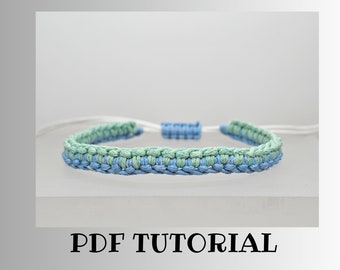 May include: A blue and green braided bracelet with white string ends. The bracelet has a simple design and is made with a knotting technique. PDF TUTORIAL is written below the bracelet.