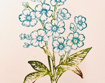 May include: A floral print featuring a cluster of blue and green flowers with detailed petals and leaves. The artwork is a stamp-like design, with a light background. The flowers are in full bloom, with a detailed stem and leaves.