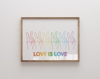 May include: A framed print with a rainbow design of seven hands making the peace sign. The text "LOVE IS LOVE" is printed below the hands.
