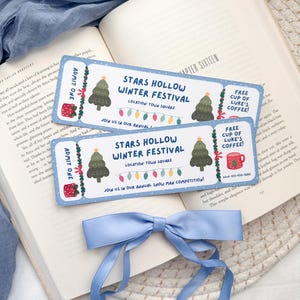May include: Two blue and white winter festival ticket bookmarks with a red and green Christmas tree illustration and the text "Stars Hollow Winter Festival" and "Free cup of Luke's Coffee!"