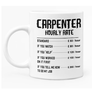 May include: White ceramic mug with a black graphic that reads "Carpenter Hourly Rate" and lists different rates for various levels of assistance. The rates are listed in pounds sterling.