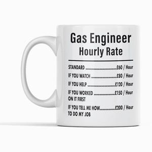 May include: White ceramic mug with a black graphic that reads "Gas Engineer Hourly Rate" and lists different hourly rates based on the level of assistance provided. The rates are listed in pounds sterling.