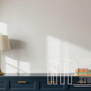 May include: A navy blue cabinet with gold handles, a gold lamp with a cream shade, and a potted plant. The image also includes a window and the text "DIGITAL ART STUDIO".