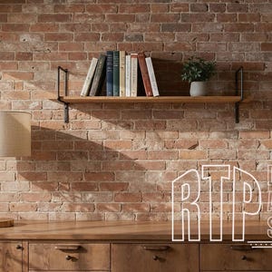 May include: A room interior featuring a wooden desk with a lamp, a brick wall, and a shelf with books and a potted plant. The text "DIGITAL ART STUDIO" is visible on the wall.
