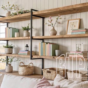 May include: A rustic wooden bookshelf with black metal supports, filled with books, vases, and decorative items. The shelves are arranged against a white paneled wall, with a window visible on the left. The overall aesthetic is a blend of farmhouse and modern design.