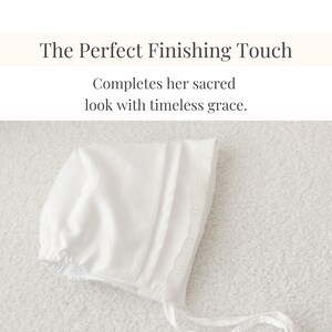 Flat lay of white bonnet with floral lace detail.