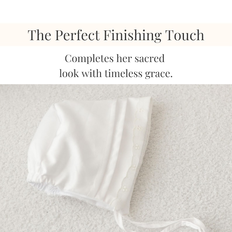 Flat lay of white bonnet with floral lace detail.