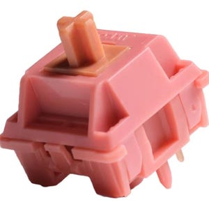 以下が含まれることがあります： ピンクの機械式キーボードスイッチで、茶色のプラスチック製のステムが付いています。