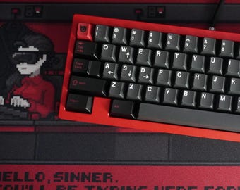 May include: A red mechanical keyboard with black keycaps sits on a red and black desk mat. The keyboard has a red frame and black keys with white lettering. The desk mat features pixel art and the text "HELLO, SINNER. YOU'LL BE TYPING HERE FOR... CHOOSE YOUR KEYBOARD."