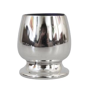 May include: A silver goblet with a round, wide bowl and a short, wide base. The goblet is highly polished and reflects the surrounding environment.