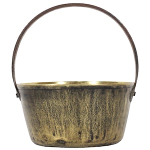 May include: A brass bucket with a brown leather handle. The bucket has a worn, aged look with a gold patina.