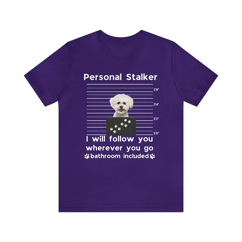 May include: Purple t-shirt with a white graphic of a white dog in a mugshot with the text "Personal Stalker" and "I will follow you wherever you go bathroom included".