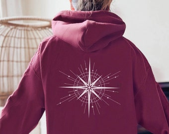 May include: Burgundy hooded sweatshirt with a white starburst design on the back.