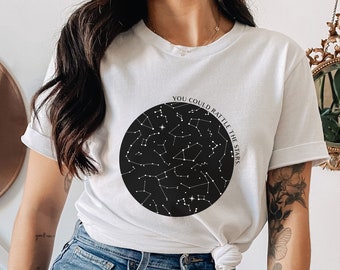 May include: White t-shirt with a black circle design featuring a constellation and the text "You could battle the stars".