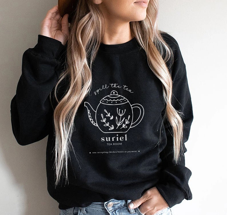May include: Black sweatshirt with a white graphic of a teapot with the text "Smell the tea" and "Suriel Tea Room".