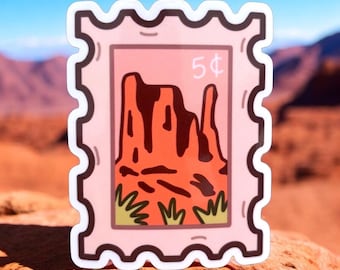May include: A pink and brown postage stamp sticker with a cartoon illustration of a red rock formation and green bushes. The stamp says "5¢" in the upper right corner.