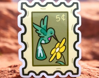 May include: A green hummingbird with a white patch on its chest is perched on a yellow flower. The image is a sticker with a vintage postage stamp design and the text "5¢" in the upper right corner.