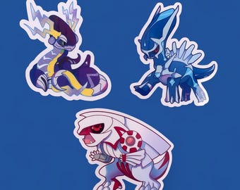 May include: Three cartoon stickers featuring Pokemon characters. The first sticker is a purple and yellow electric type Pokemon with lightning bolts. The second sticker is a blue and white Pokemon with a spiky back. The third sticker is a white and red Pokemon with a red and white shield on its back.