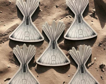 May include: Six black and white illustrations of teepees on a sandy background. The teepees are drawn in a simple style with a few lines and details.