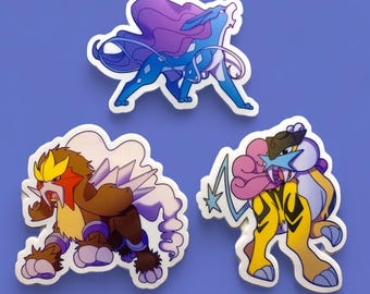 May include: Three Pokemon stickers featuring a blue and purple water-type Pokemon, a brown and yellow fire-type Pokemon, and a yellow and pink electric-type Pokemon.