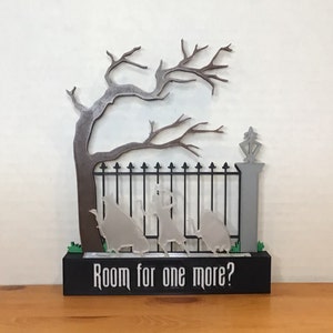 May include: A 3D printed Halloween decoration featuring a black iron gate with a spooky tree and three ghostly figures. The base of the decoration has a black background with the text "Room for one more?"