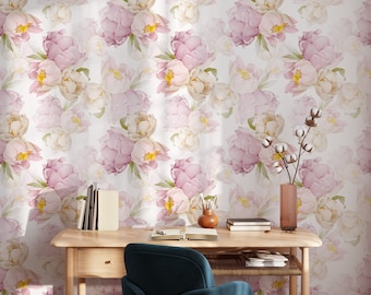 May include: A wooden desk with a blue office chair in front of it. The desk has a drawer and a shelf. The wall behind the desk is covered in a floral wallpaper with pink and white peonies.