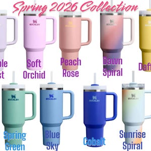 May include: A collection of Stanley tumblers in various colors, including purple, pink, peach, and yellow. Each tumbler has a handle, a straw, and the Stanley logo. The text "Spring 2026 Collection" is displayed at the top.