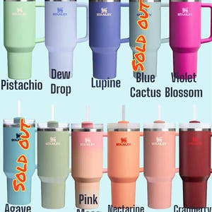 May include: A collection of Stanley tumblers in various colors, including Pistachio, Dew Drop, Lupine, Violet Cactus Blossom, Agave, Lichen, Pink Mesa Sunset, Nectarine, Sienna, and Cranberry. Each tumbler has a handle, straw, and the Stanley logo.