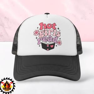 May include: A black and white trucker hat featuring a graphic print on the front panel. The design includes the text "hot girls read" in pink and purple wavy letters, accompanied by small flower icons, star shapes, and an open book with a heart.