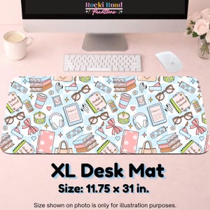 May include: An XL desk mat featuring a repeating pattern of books, journals labeled Bookish Journal, e-readers, glasses, headphones, candles, bows, and coffee cups on a light blue and white checkered background, measuring 11.75 by 31 inches.