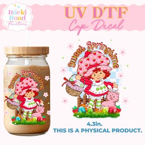 May include: A 4.3 inch UV DTF cup decal featuring a cartoon strawberry character holding a basket of eggs and a bunny. The decal says "Sweet Springtime" in a pink and white banner.