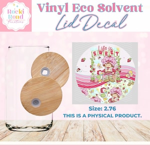 May include: A round vinyl decal with a pink and green strawberry theme. The decal features a cartoon strawberry character with the text "Life is Sweet". The decal is 2.76 inches in diameter.