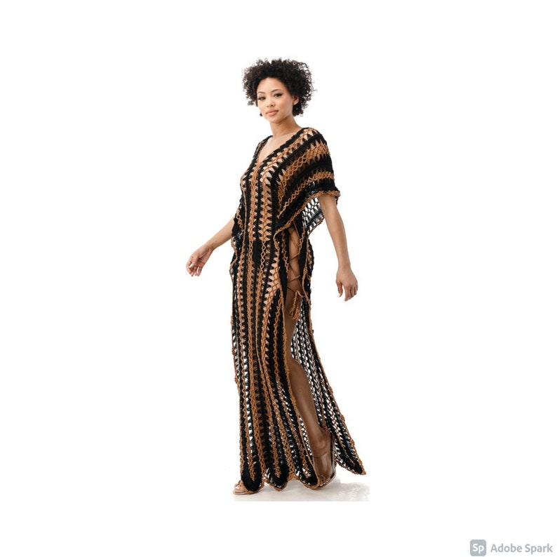 May include: A long, black and brown crochet maxi dress with a V-neckline and a side slit. The dress is made of a lightweight, breathable fabric and is perfect for a day at the beach or a summer evening out.