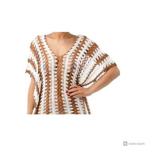 May include: A white and brown crochet cover-up with a v-neck and short sleeves.