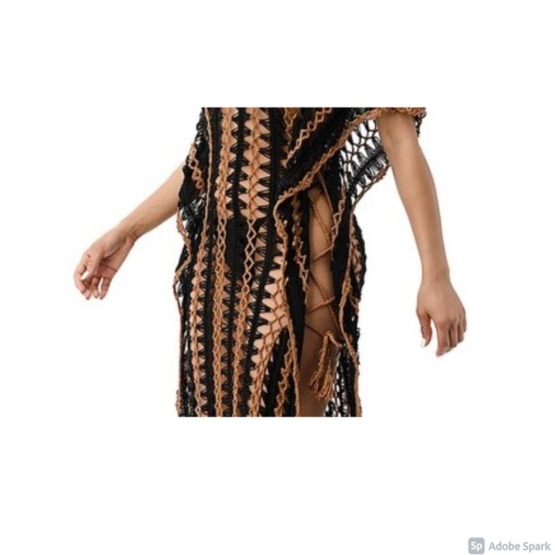 May include: A black and brown crochet cover-up with a side tie detail. The cover-up is made of a lightweight, breathable fabric and is perfect for the beach or pool.