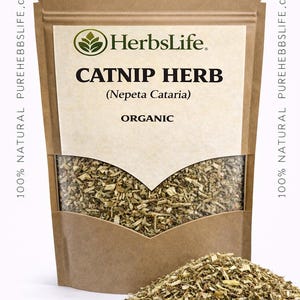 May include: A brown paper bag filled with dried catnip herb, with a pile of the herb in front. The bag has a white label with the text "HerbsLife" and "CATNIP HERB (Nepeta Cataria) ORGANIC". The text "100% NATURAL PUREHEBBSLIFE.com" is printed on the sides.