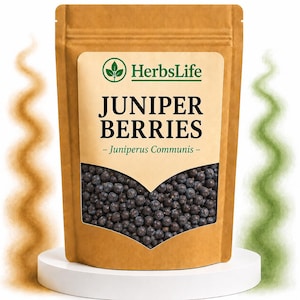 May include: A brown paper pouch containing dark purple juniper berries. The label features the text HerbsLife, JUNIPER BERRIES, and Juniperus Communis. The pouch has a clear window showing the berries and sits on a white circular base.
