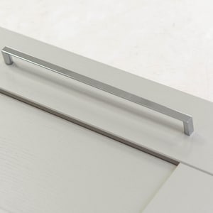 May include: A silver cabinet door handle with a rectangular shape.