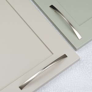 May include: Two cabinet doors with brushed nickel cabinet pulls. The cabinet doors are a light green colour.
