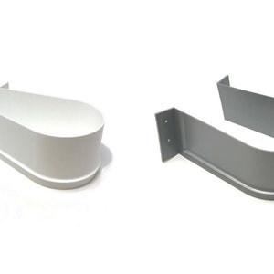 May include: Two U-shaped plastic brackets, one white and one gray. The brackets are designed to be mounted to a wall or other surface and have a curved shape to hold a pipe or other object.